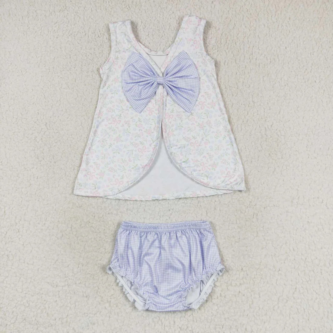 Swing back bloomer set with floral and bow patterned top. Purple gingham bloomers and bow on back of top